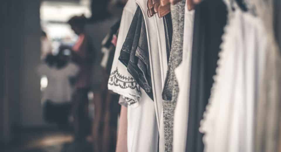 clothes hanging in a boutique - top 6 technology impacts on fashion trends